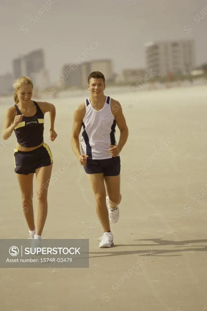 Young couple jogging on the beach