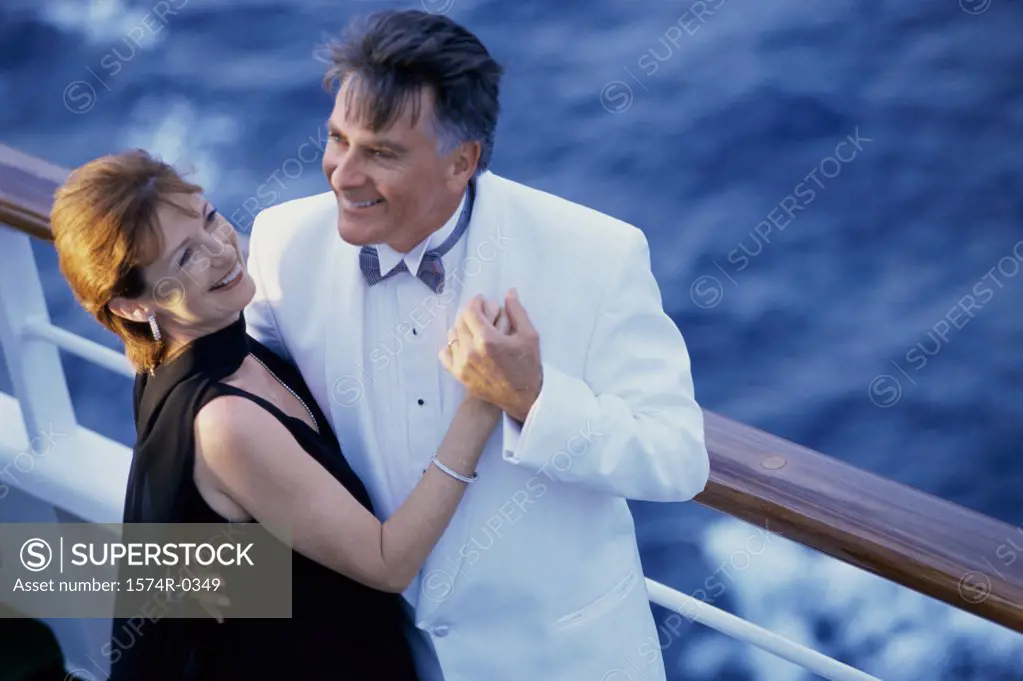 Couple holding each other on a ship