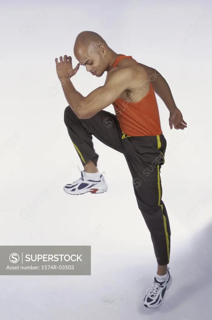 Side profile of young man lifting his leg
