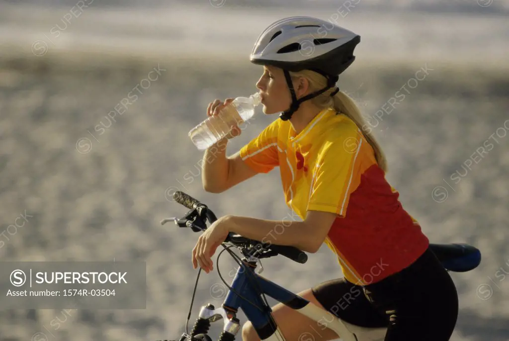 Young woman drinking from water bottle