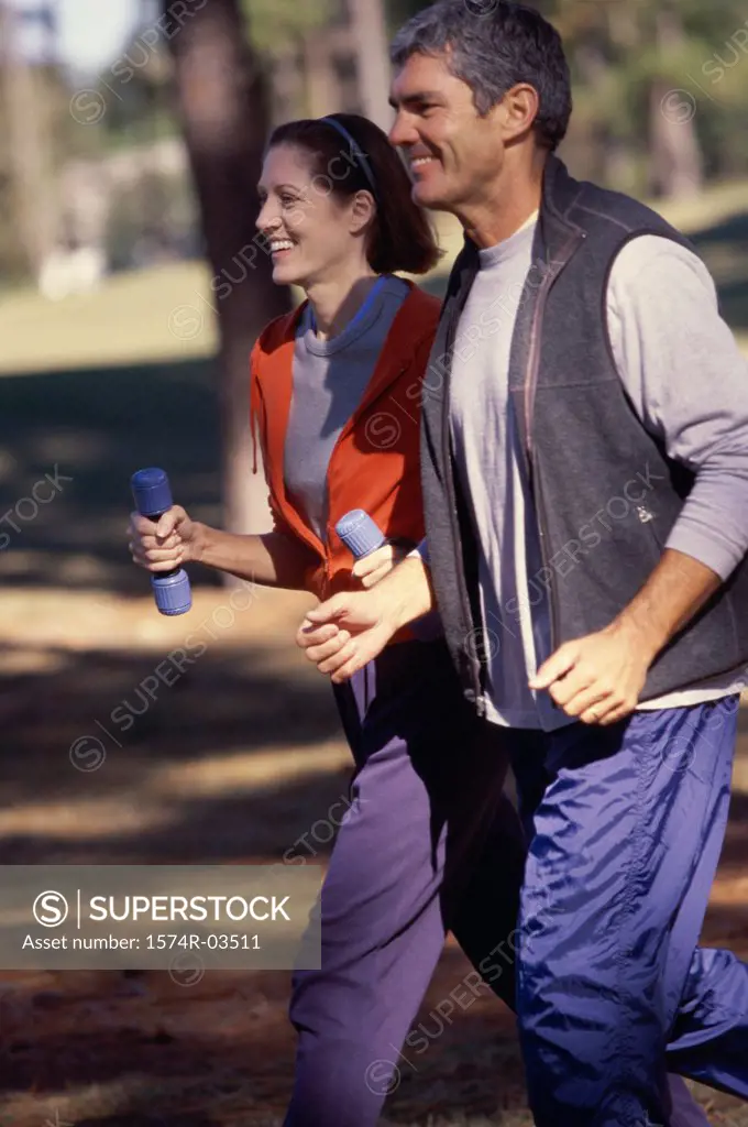 Side profile of a mid adult couple jogging together