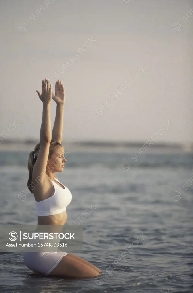 Young woman exercising on the beach