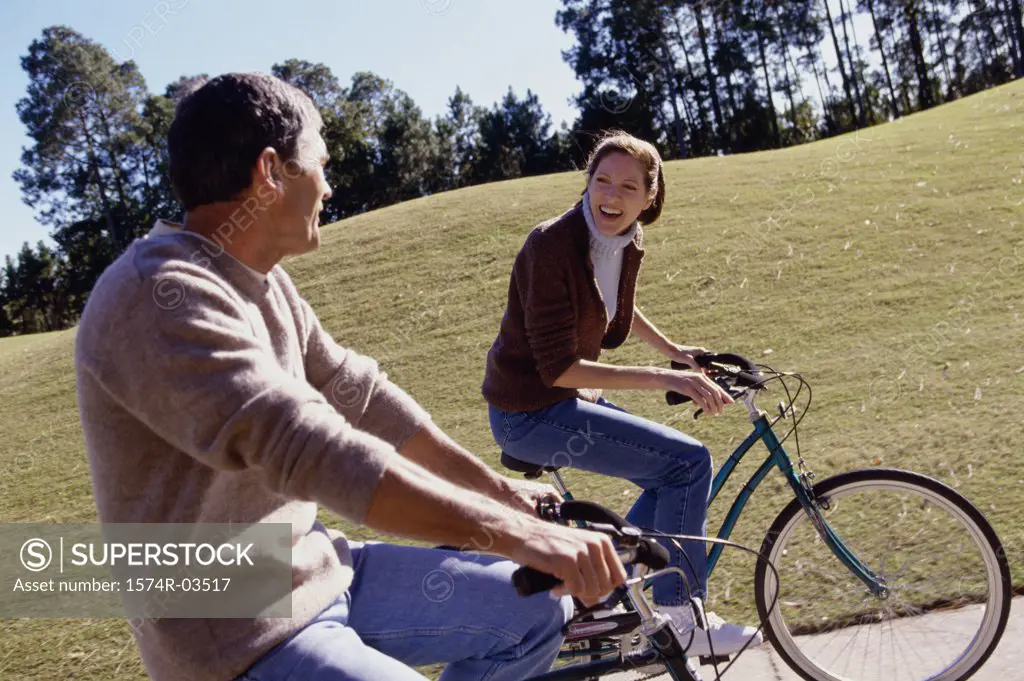 Mid adult couple riding bicycles