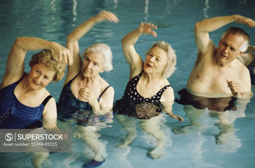 Group of senior people stretching in a swimming pool
