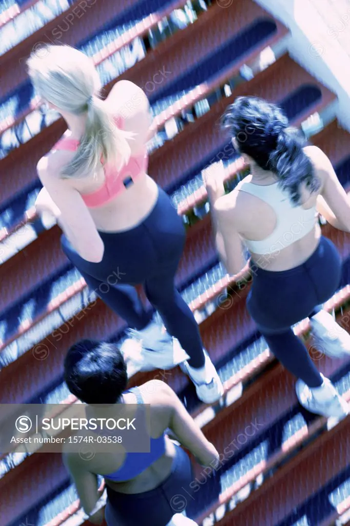 High angle view of three young women jogging