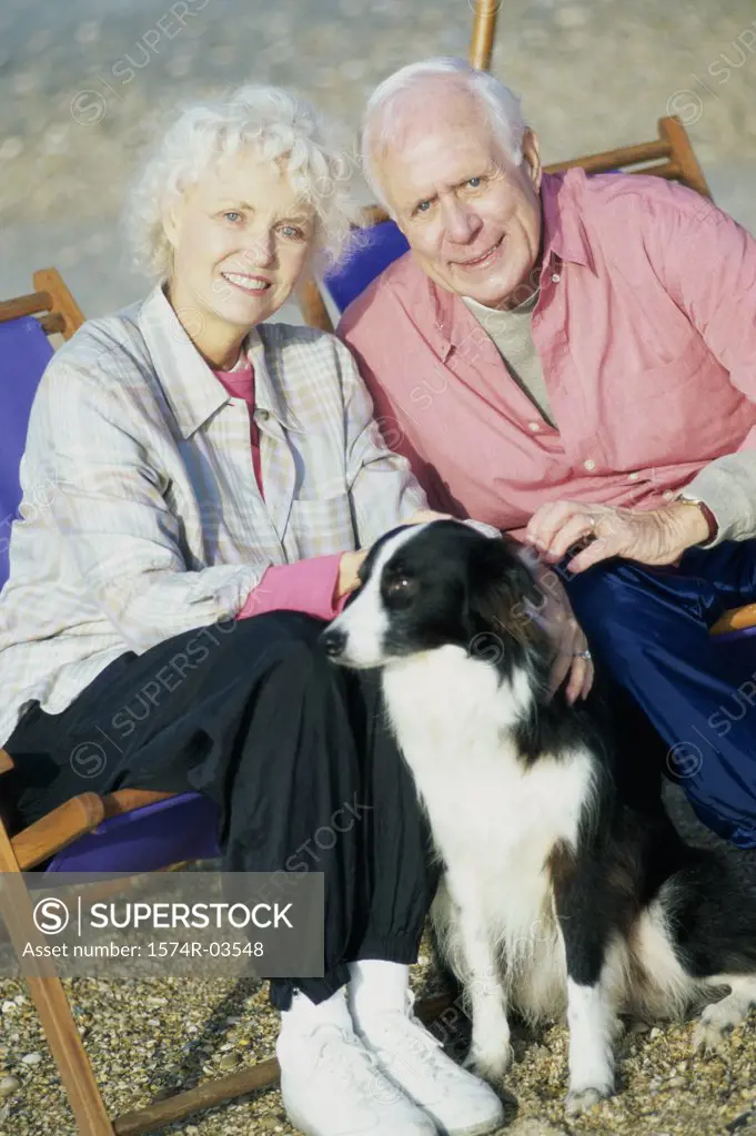 Portrait of a senior couple sitting with their dog