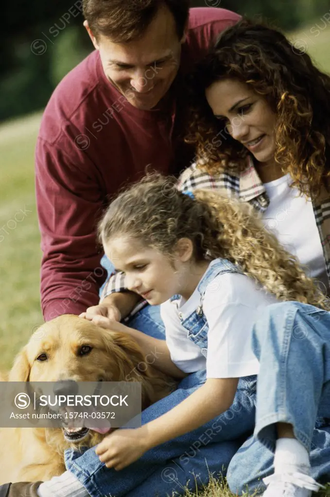 Parents with their daughter and a dog