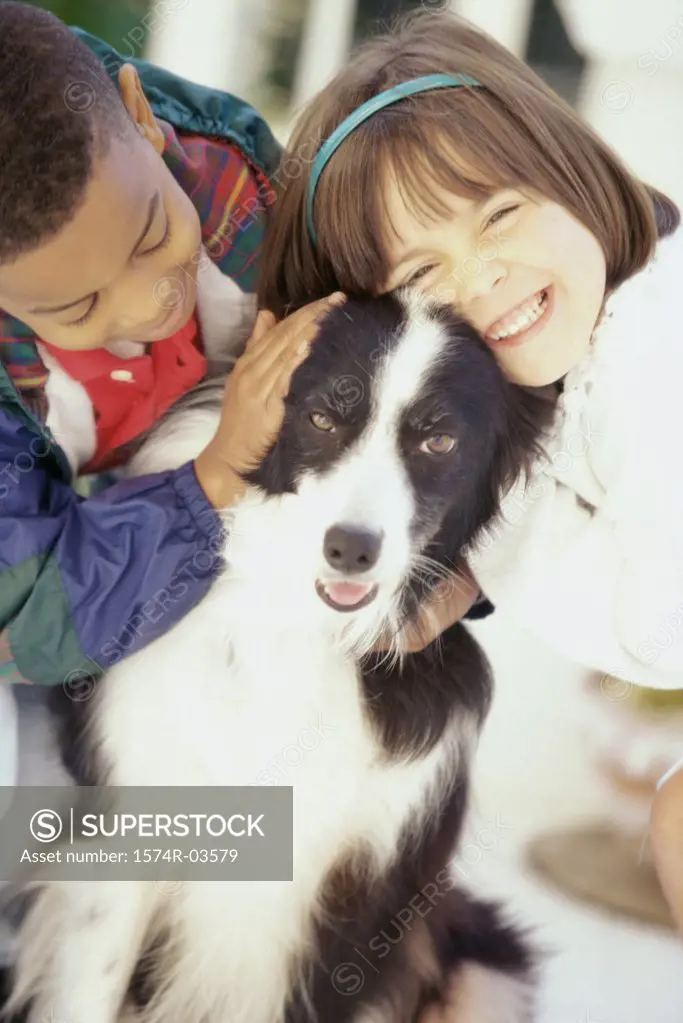 Portrait of a girl and a boy petting a dog