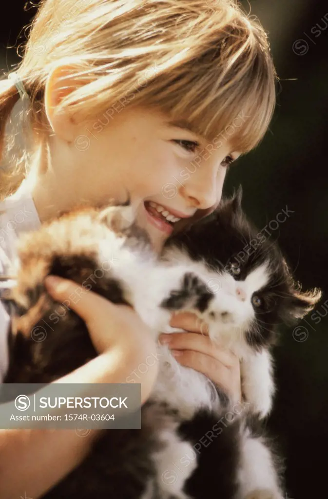 Close-up of a girl holding cats