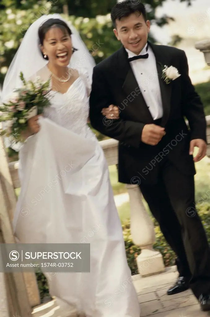 Portrait of a newlywed couple walking arm in arm