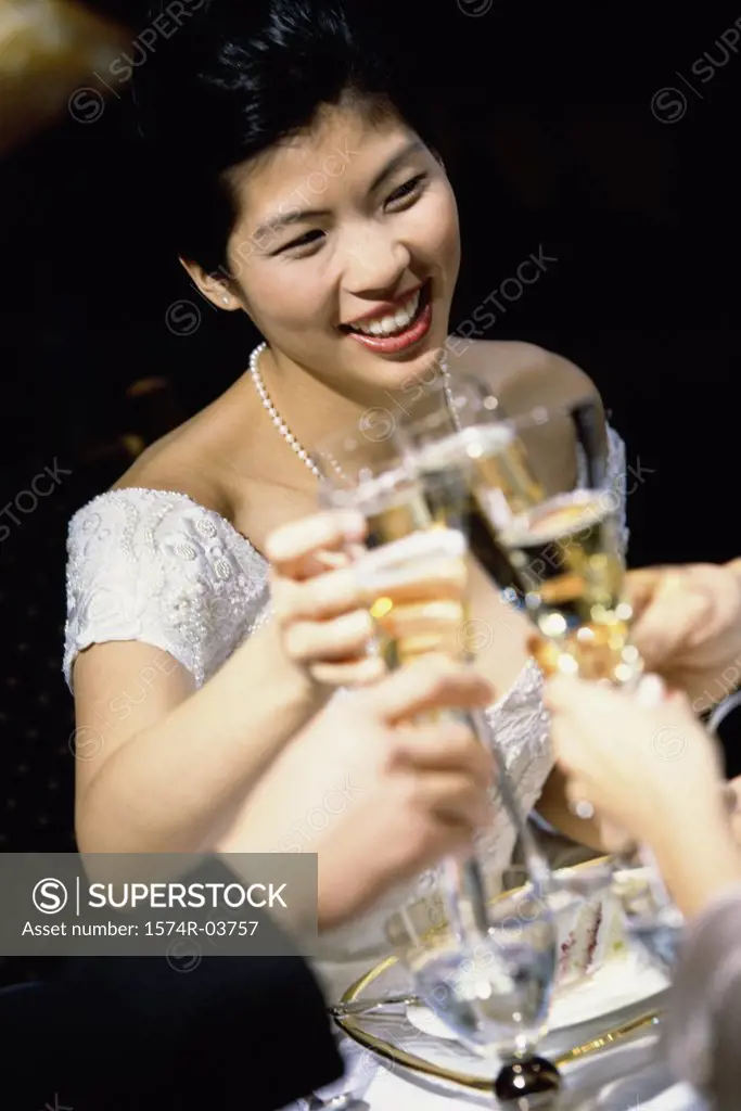Bride toasting with glasses of champagne