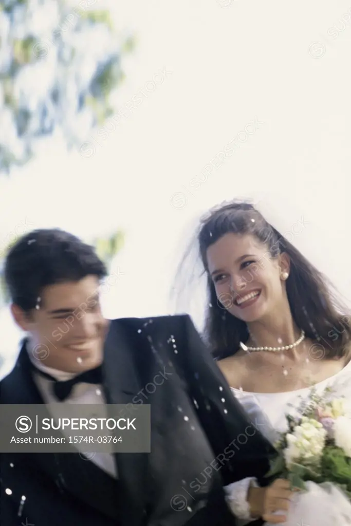 Confetti falling on a newlywed couple