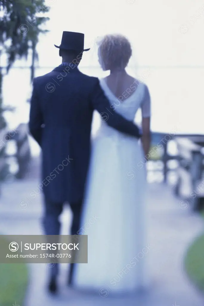 Rear view of a newlywed couple walking