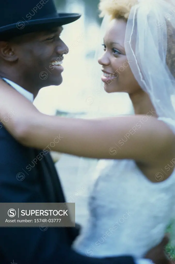 Side profile of a newlywed couple embracing each other