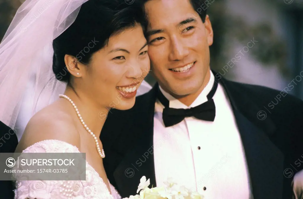 Close-up of a newlywed couple smiling