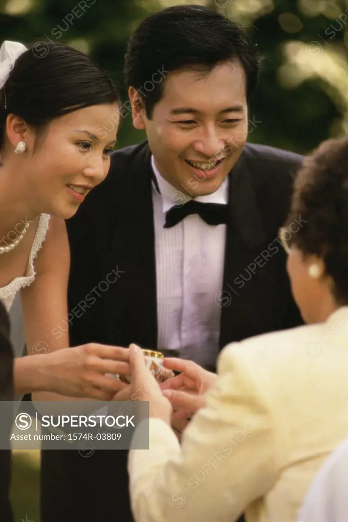 Bride offering tea to her mother