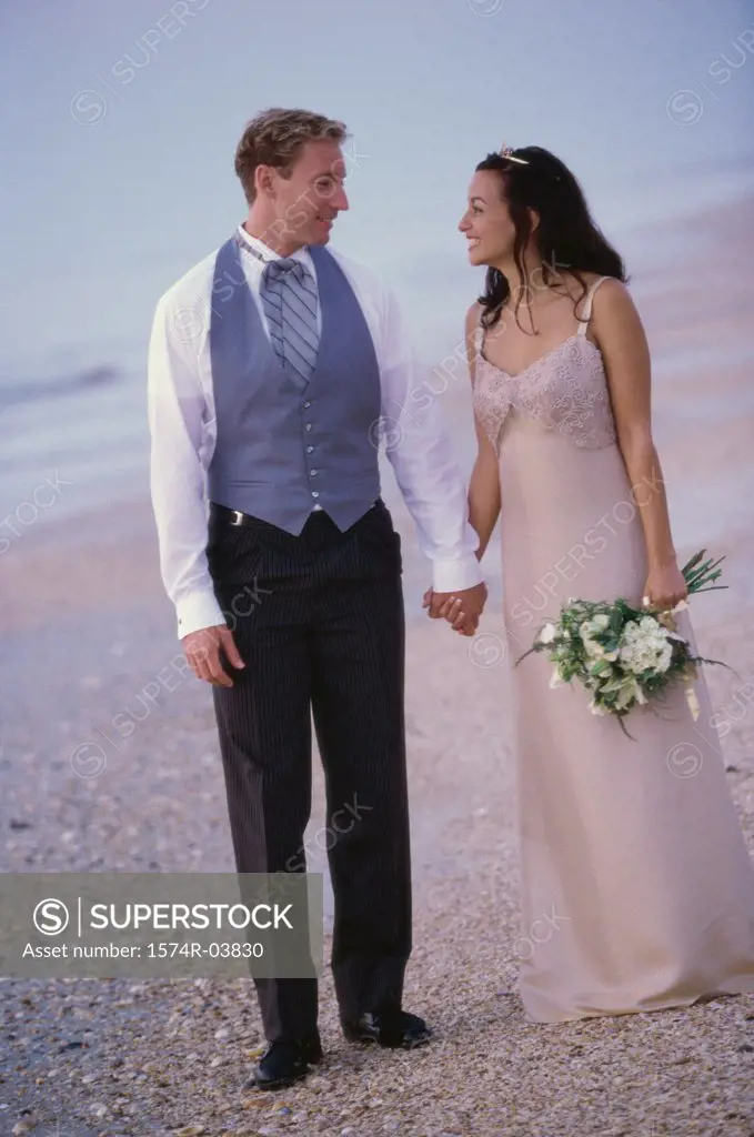 Young couple standing together on the beach