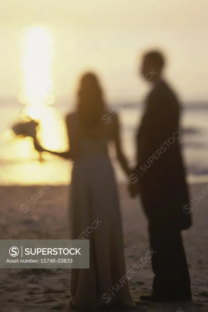 Newlywed couple standing on the beach