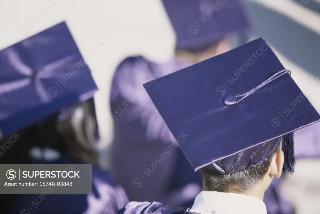 Rear view of young graduates