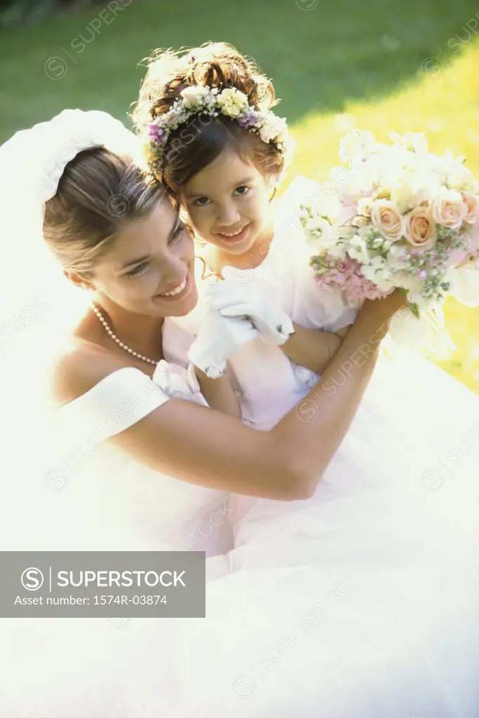 High angle view of a bride smiling with a flower girl