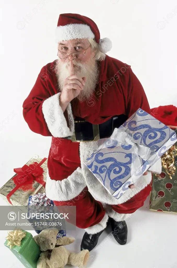 High angle view of Santa Claus with his finger on his lips