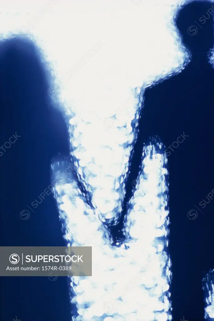 Silhouette of a couple holding hands