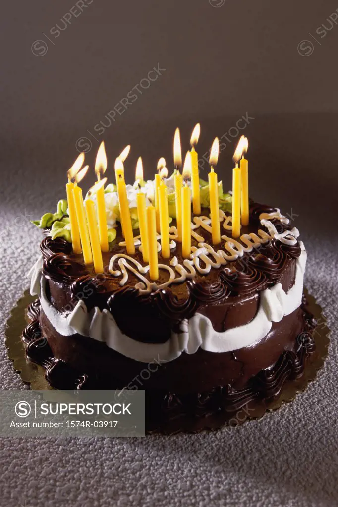 Decorated birthday cake with lit candles