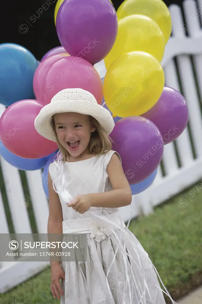 Girl holding balloons