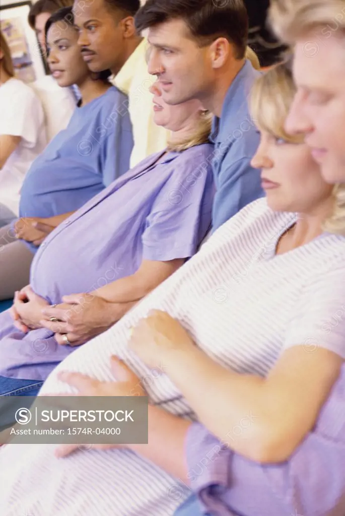 Husbands and their pregnant wives at a prenatal class