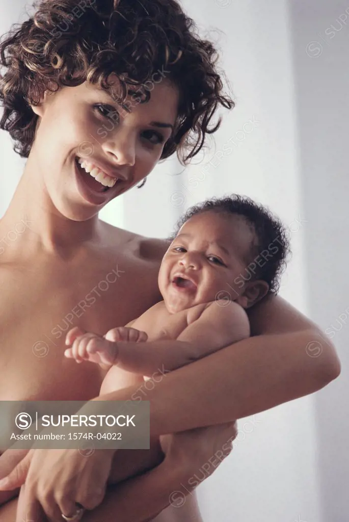 Portrait of a mother carrying her baby boy