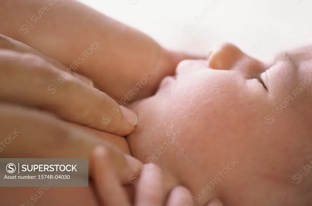 Person's hand on a sleeping baby boy
