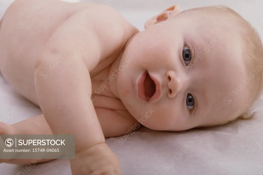 Close-up of a baby boy lying on his side