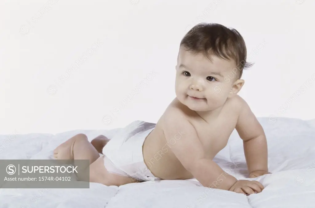Baby boy crawling on a bed