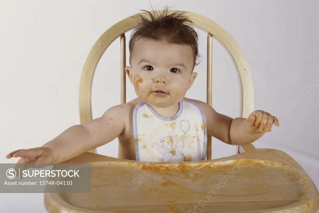 Portrait of a baby boy sitting in a high chair