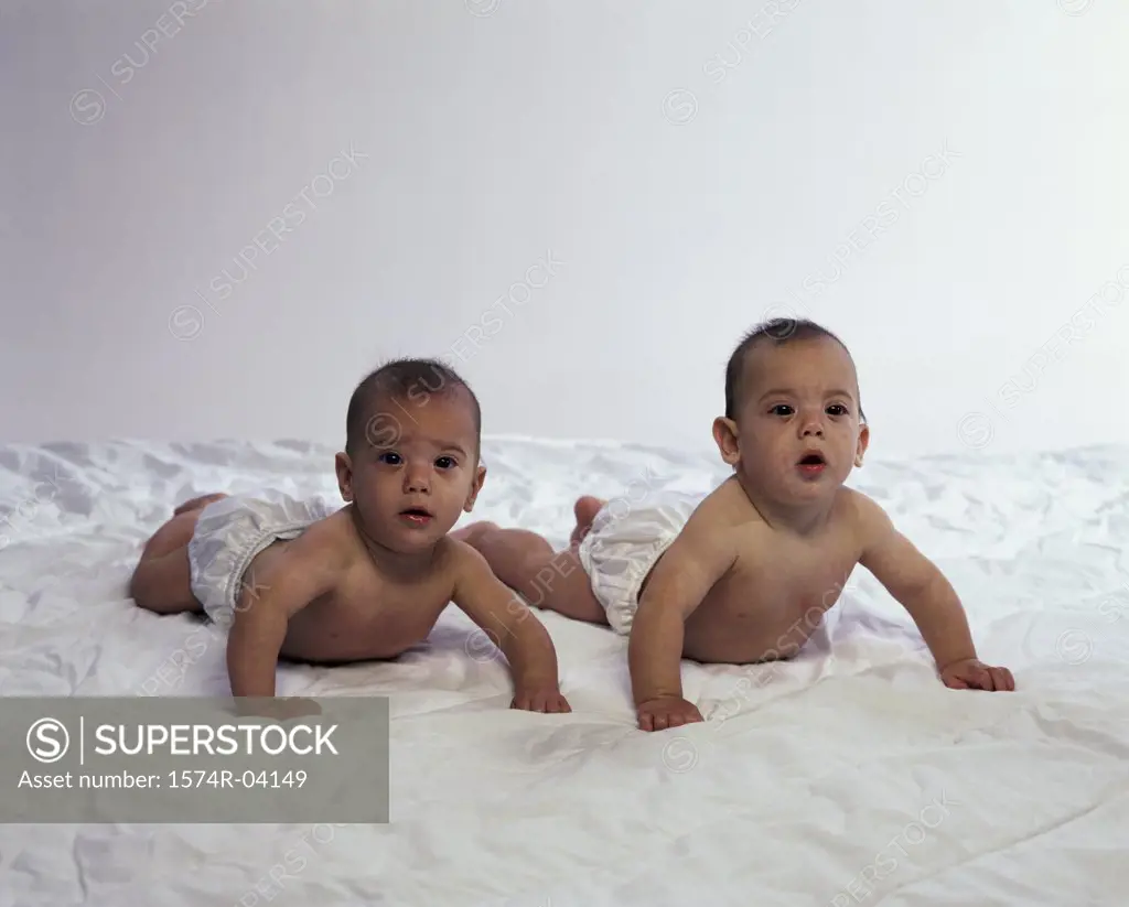 Portrait of two baby boys wearing diapers
