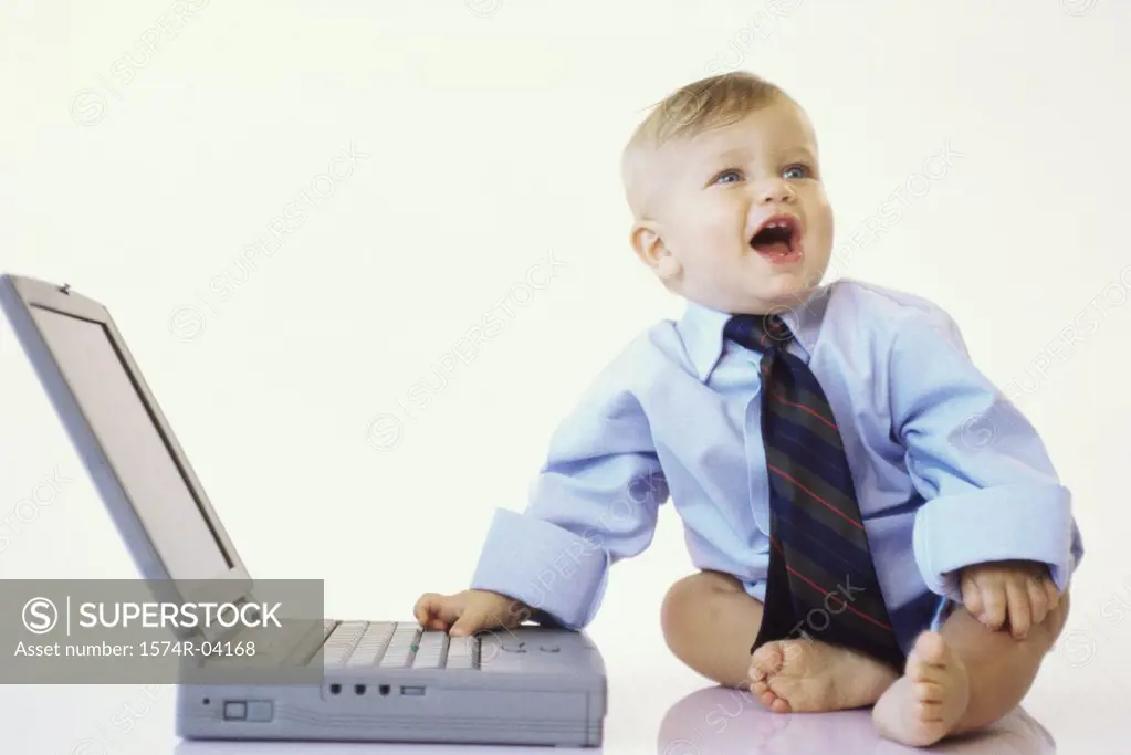 Baby boy touching a laptop