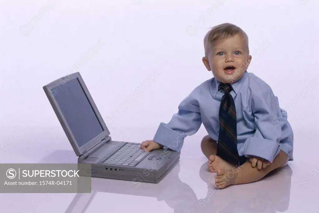 Baby boy touching a laptop