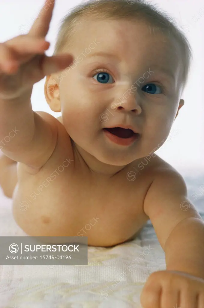 Portrait of a baby boy raising his hand