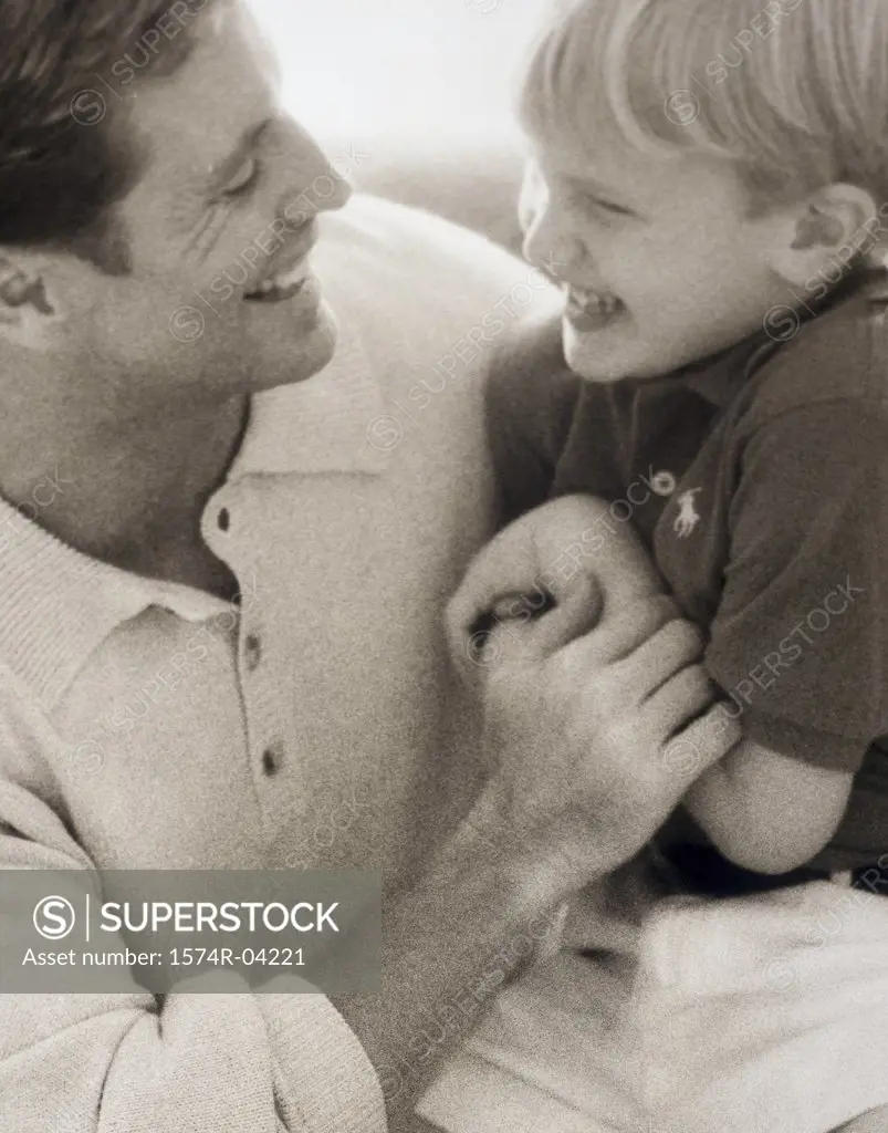 Close-up of a father laughing with his son