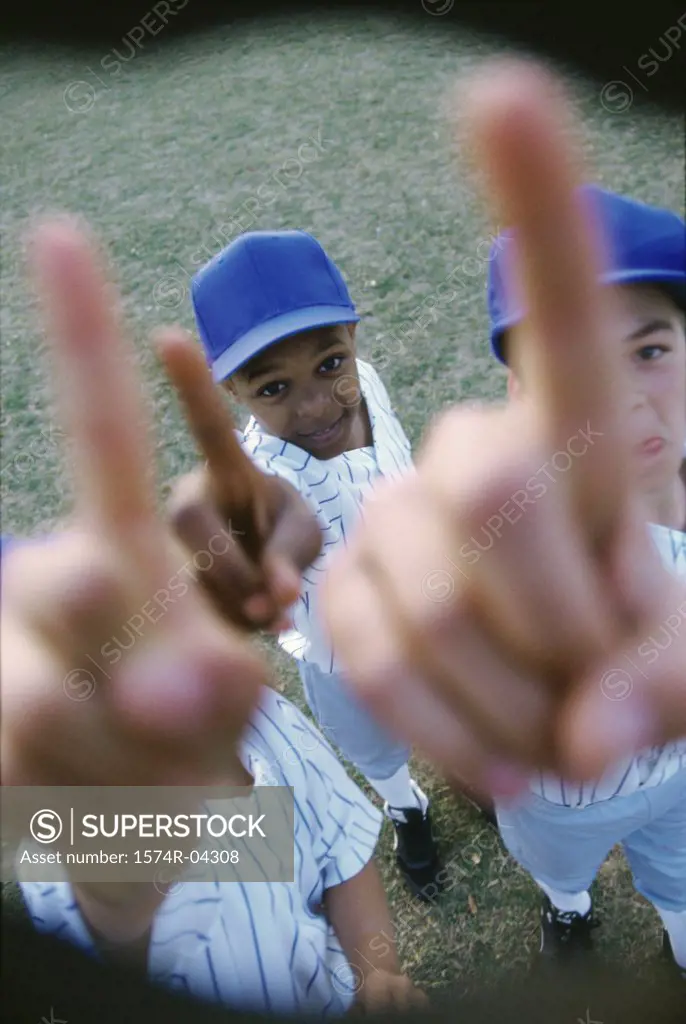 High angle view of three boys from a youth league baseball team