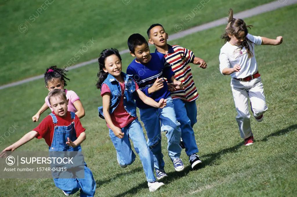 Group of children running on a lawn