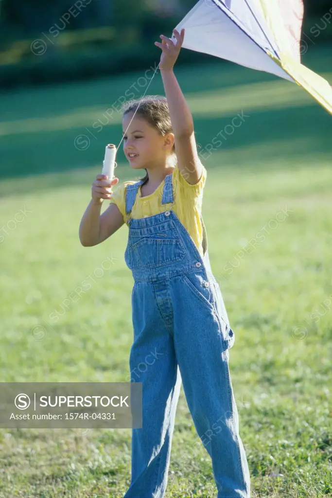 Front view of a girl holding a kite
