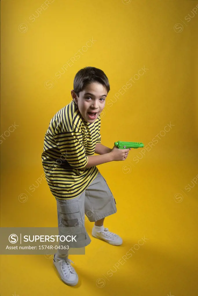 Portrait of a boy holding a squirt gun
