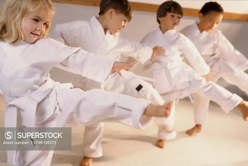 Group of children learning karate