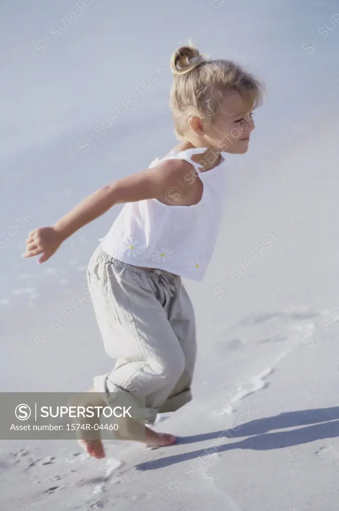 Side profile of a girl running on the beach