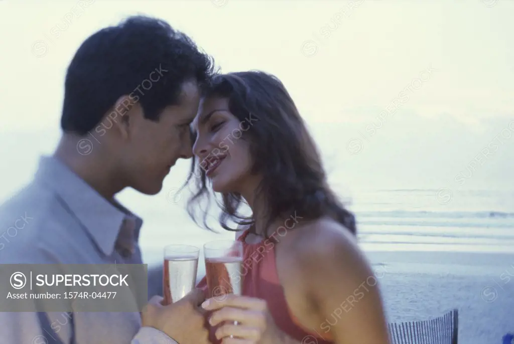 Close-up of a young couple toasting outdoors
