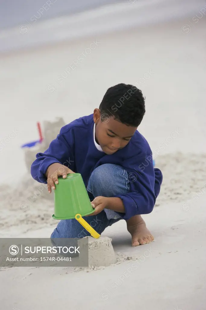 Boy building a sand castle on the beach