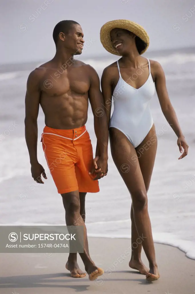 Young couple walking on the beach together