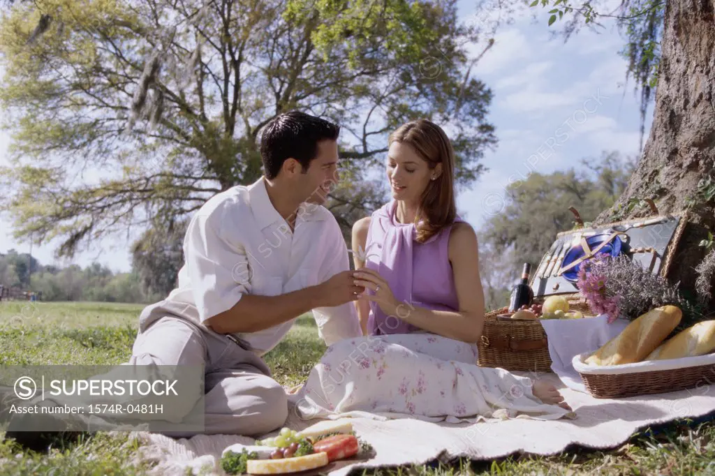 Young couple sitting together at a picnic