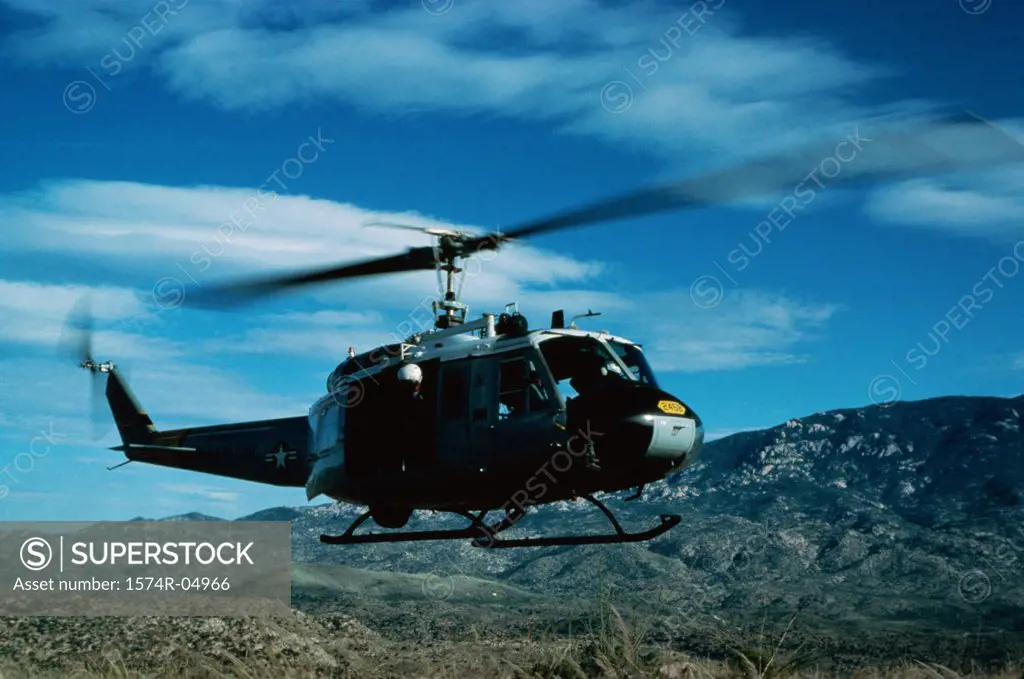 Low angle view of a UH-1 Iroquois in flight